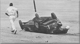 As track attendant rushes for aid, John Hooper struggles to free himself.